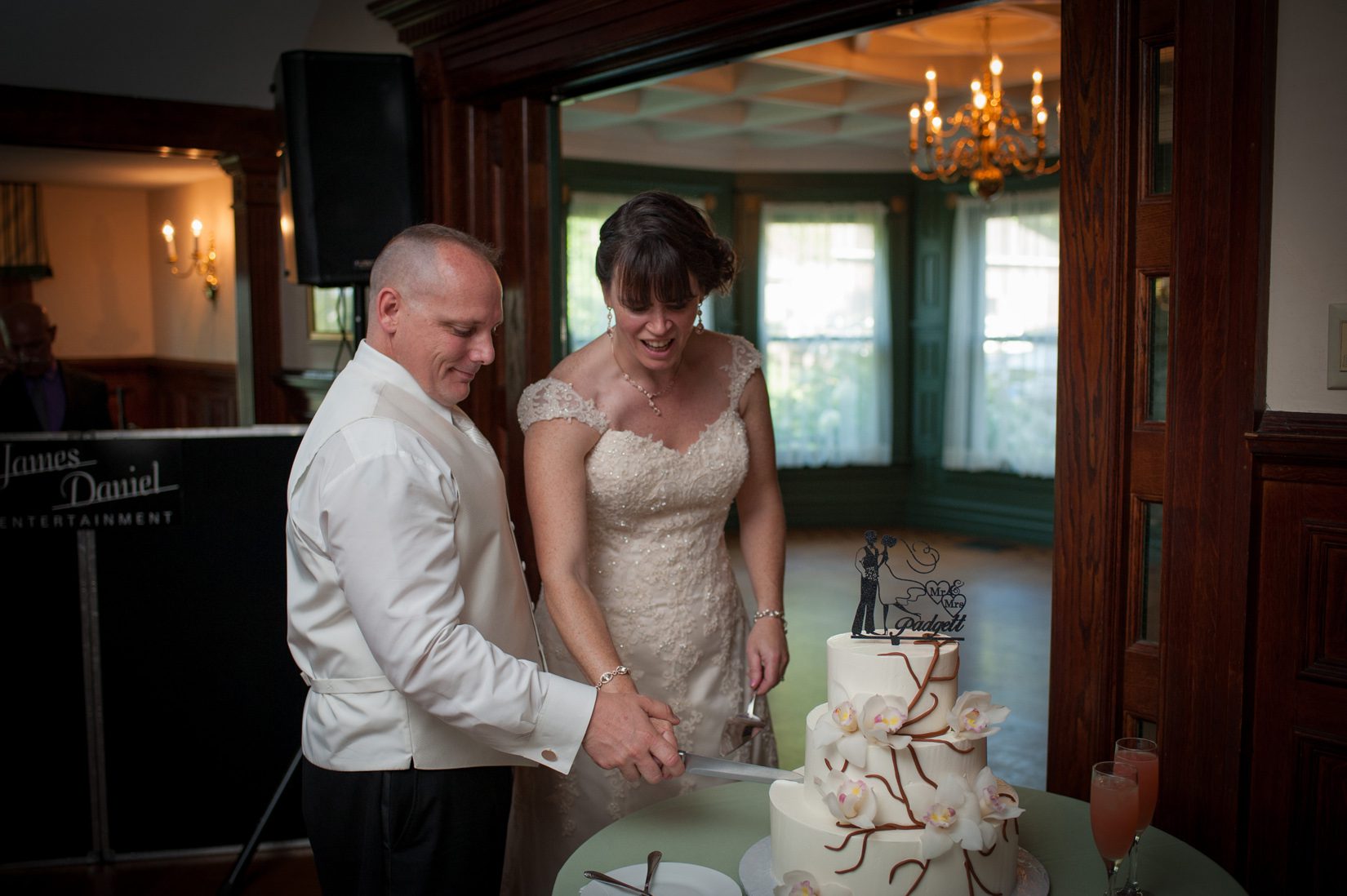 Vendor Spotlight: Monet Baking Company couple cutting three tier cake