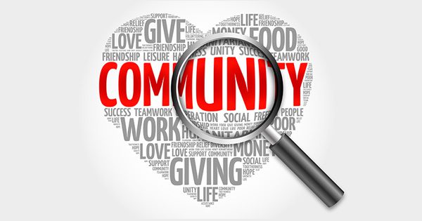 Community Action Agency heart graphic with community and magnifying glass