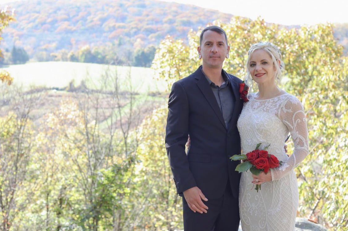 greg and julia with hayfields in background